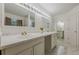 Bright bathroom featuring double sinks, marble counters, and tile flooring at 303 Cimarron Way, Lawrenceville, GA 30044