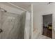 Bright bathroom with tiled shower and soaking tub with a view to the Primary bedroom at 303 Cimarron Way, Lawrenceville, GA 30044