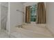 Corner bathtub and separate shower in this bright bathroom with marble floors at 303 Cimarron Way, Lawrenceville, GA 30044