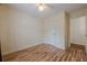 A comfortable bedroom with hardwood floors, an overhead fan, and an adjoining doorway at 303 Cimarron Way, Lawrenceville, GA 30044
