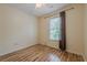 Cozy bedroom featuring hardwood floors, a window for natural light, and neutral wall color at 303 Cimarron Way, Lawrenceville, GA 30044