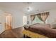 Bright bedroom features a ceiling fan, large windows with curtains, and wood-look flooring at 303 Cimarron Way, Lawrenceville, GA 30044
