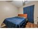 A cozy bedroom with a wooden bed frame and simple decor, featuring hardwood floors at 303 Cimarron Way, Lawrenceville, GA 30044