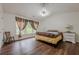 Vaulted ceiling bedroom with hardwood floors, large window, and neutral decor at 303 Cimarron Way, Lawrenceville, GA 30044