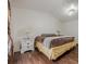 Vaulted ceiling bedroom with hardwood floors, bright window, and side table at 303 Cimarron Way, Lawrenceville, GA 30044
