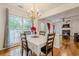 Cozy dining area with a chandelier, large windows, and hardwood floors at 303 Cimarron Way, Lawrenceville, GA 30044