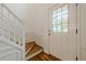 Bright entryway featuring hardwood floors, white trim, and a staircase leading to the upper level at 303 Cimarron Way, Lawrenceville, GA 30044