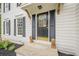 Close-up of a home's front entrance with lion statues flanking the door, and black mulch landscaping at 303 Cimarron Way, Lawrenceville, GA 30044