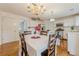 Bright eat-in kitchen with stainless steel appliances, white cabinets, and tile backsplash at 303 Cimarron Way, Lawrenceville, GA 30044