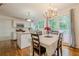 Open kitchen with island, stainless appliances, white cabinets, and adjacent dining area at 303 Cimarron Way, Lawrenceville, GA 30044