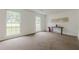 Spacious living room with neutral carpet, large windows, and minimalist decor with a side table at 303 Cimarron Way, Lawrenceville, GA 30044