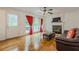 Cozy living room featuring a fireplace, ceiling fan, and hardwood floors at 303 Cimarron Way, Lawrenceville, GA 30044