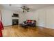 Comfortable living room with fireplace, hardwood floors, and ceiling fan at 303 Cimarron Way, Lawrenceville, GA 30044