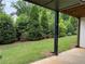 Manicured backyard with lush green grass, mature trees, and shrubbery at 4382 Benfield Se Way, Smyrna, GA 30080