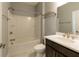 Bathroom featuring a shower-tub combination, vanity with modern fixtures, and neutral tile flooring at 4382 Benfield Se Way, Smyrna, GA 30080