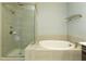 This bathroom features a glass-enclosed shower, a large tub, and ceramic tiling at 4382 Benfield Se Way, Smyrna, GA 30080