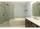 Modern bathroom featuring a glass-enclosed shower, soaking tub, and vanity with sink at 4382 Benfield Se Way, Smyrna, GA 30080