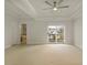 Spacious bedroom featuring a tray ceiling, ceiling fan, and sliding door to an outdoor deck at 4382 Benfield Se Way, Smyrna, GA 30080
