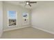 A carpeted bedroom with two windows and a ceiling fan at 4382 Benfield Se Way, Smyrna, GA 30080