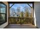 Outdoor deck with wood railing and a view of the surrounding neighborhood and trees at 4382 Benfield Se Way, Smyrna, GA 30080