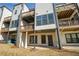 Exterior view of the back of the home featuring balconies on each level and a patio at 4382 Benfield Se Way, Smyrna, GA 30080