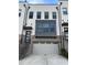 Townhome with brick accents, dark-trimmed windows, and a 2-car garage offers curb appeal at 4382 Benfield Se Way, Smyrna, GA 30080