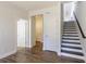 Hallway featuring hardwood floors, white doors, and stairs with dark wood accents at 4382 Benfield Se Way, Smyrna, GA 30080