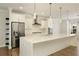 Modern kitchen featuring a large island, stainless steel appliances, and stylish pendant lights at 4382 Benfield Se Way, Smyrna, GA 30080