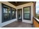 Covered porch featuring dark framed windows and a door that opens to the outside at 4382 Benfield Se Way, Smyrna, GA 30080