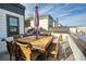 Outdoor rooftop dining area features a large wooden table with seating for eight, ideal for al fresco meals at 4382 Benfield Se Way, Smyrna, GA 30080