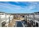 Exterior street view of townhomes with city skyline background at 4382 Benfield Se Way, Smyrna, GA 30080