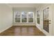 Light-filled sun room with hardwood floors, large windows, and a door leading to an outdoor deck at 4382 Benfield Se Way, Smyrna, GA 30080