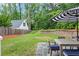 Backyard dining area features a patio, outdoor table and chairs, and lawn at 686 Amsterdam Ne Ave, Atlanta, GA 30306