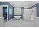 A bathroom featuring a soaking tub, glass shower, marble tile, and white cabinets at 686 Amsterdam Ne Ave, Atlanta, GA 30306