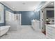 A bathroom featuring a soaking tub, glass shower, double vanity with marble countertops and herringbone tile flooring at 686 Amsterdam Ne Ave, Atlanta, GA 30306