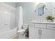 A secondary bathroom featuring white subway tile, shower-tub, and white cabinets at 686 Amsterdam Ne Ave, Atlanta, GA 30306