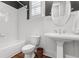 Bathroom featuring a tub, herringbone tile, toilet, and pedestal sink at 686 Amsterdam Ne Ave, Atlanta, GA 30306