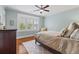 A secondary bedroom with light blue walls, wood floors, plantation shutters, and neutral decor at 686 Amsterdam Ne Ave, Atlanta, GA 30306