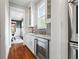 Convenient butler pantry with white cabinetry, granite countertops, and a wine refrigerator at 686 Amsterdam Ne Ave, Atlanta, GA 30306