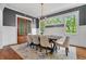 Beautiful dining area featuring modern chandelier, gray accent wall and rich hardwood floors at 686 Amsterdam Ne Ave, Atlanta, GA 30306