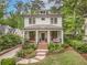 Charming two-story home with landscaped yard, brick stairs, and a welcoming front porch at 686 Amsterdam Ne Ave, Atlanta, GA 30306