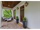 Inviting front porch with brick flooring, outdoor seating, and stylish exterior lighting at 686 Amsterdam Ne Ave, Atlanta, GA 30306