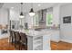 Modern white kitchen features a large island with seating and stainless steel appliances at 686 Amsterdam Ne Ave, Atlanta, GA 30306