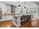 Modern kitchen featuring a large island with seating, stainless steel appliances, and hardwood floors at 686 Amsterdam Ne Ave, Atlanta, GA 30306