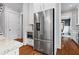 Kitchen with stainless steel refrigerator and appliances next to pantry and doorways at 686 Amsterdam Ne Ave, Atlanta, GA 30306