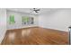 Sun-filled living room with hardwood floors, a ceiling fan, and large windows overlooking the backyard at 686 Amsterdam Ne Ave, Atlanta, GA 30306