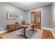Home office featuring desk, gray walls, wood doors and wainscoting at 686 Amsterdam Ne Ave, Atlanta, GA 30306