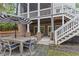 Inviting outdoor patio with table, chairs, brickwork, and stairs to an upper deck at 686 Amsterdam Ne Ave, Atlanta, GA 30306