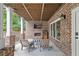 Cozy brick patio with a fireplace, mounted TV, and comfortable seating at 686 Amsterdam Ne Ave, Atlanta, GA 30306