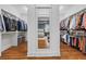 A walk-in closet with custom shelving and a full-length mirror reflecting the bedroom at 686 Amsterdam Ne Ave, Atlanta, GA 30306